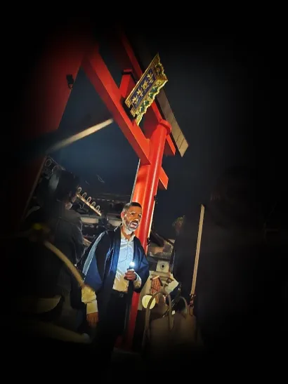 The Guide of the Nara Ghost Walk in front of a shrine in Naramachi area